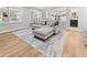 Inviting living room featuring a large sectional sofa, wood floors, and an open layout connecting to the kitchen at 1055 Royalist Rd, Mount Pleasant, SC 29464