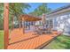 A beautiful outdoor space with a custom deck, covered outdoor kitchen, bar, and a dining area with outdoor seating at 110 Salinas Ct, Summerville, SC 29483