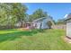 Lush backyard with a custom deck featuring an outdoor kitchen, bar, dining area, and ample green space at 110 Salinas Ct, Summerville, SC 29483