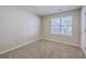 Cozy bedroom with neutral walls, carpet, and a window letting in natural light at 110 Salinas Ct, Summerville, SC 29483