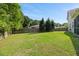 Large, grassy backyard featuring a tall wooden privacy fence and mature trees along the perimeter at 111 Gavins Way, Goose Creek, SC 29445