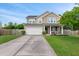 Charming two-story home features a well-manicured lawn, attached two-car garage, and inviting front porch at 111 Gavins Way, Goose Creek, SC 29445