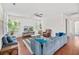Spacious living room with hardwood floors, comfortable seating, and plenty of natural light through the windows at 111 Gavins Way, Goose Creek, SC 29445