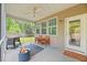 Relaxing screened porch with fire pit, seating, and ceiling fan is perfect for outdoor enjoyment at 111 Gavins Way, Goose Creek, SC 29445