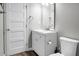 A bathroom with a white cabinet sink, toilet and a white, four-panel door at 113 Owens Cir, Summerville, SC 29483