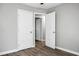 An empty bedroom with light gray walls, hardwood floors, and a pair of white doors at 113 Owens Cir, Summerville, SC 29483