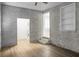 Unique bedroom with exposed brick, stylish laminate flooring, and built in shelves at 113 Owens Cir, Summerville, SC 29483