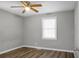 An empty bedroom with light gray walls, hard wood floors, a window, and a ceiling fan at 113 Owens Cir, Summerville, SC 29483