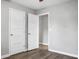 An empty bedroom with light gray walls, hardwood floors, and two white doors at 113 Owens Cir, Summerville, SC 29483