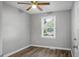 An empty bedroom with gray walls, hardwood floors, a window, and a ceiling fan at 113 Owens Cir, Summerville, SC 29483