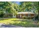 Quaint brick and siding home with a well-maintained lawn and mature trees in a peaceful neighborhood at 113 Owens Cir, Summerville, SC 29483