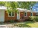 Close up of brick and siding home featuring a charming front porch and meticulously maintained landscaping at 113 Owens Cir, Summerville, SC 29483