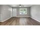 Well-lit living room with laminate flooring, large window, and neutral paint at 113 Owens Cir, Summerville, SC 29483