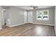 Bright living room featuring laminate flooring, ceiling fan, and natural light at 113 Owens Cir, Summerville, SC 29483