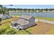 Aerial view of home's backyard oasis, featuring a covered patio, firepit, and lake views at 1132 Wading Point Blvd, Huger, SC 29450
