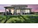 View of the cozy covered back patio and fenced backyard with patio furniture and exterior lighting at 1132 Wading Point Blvd, Huger, SC 29450