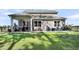 Spacious backyard with a screened-in patio and ample outdoor seating areas at 1132 Wading Point Blvd, Huger, SC 29450