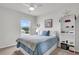 Comfortable bedroom featuring a queen-size bed, a window, and a decorative bookshelf at 1132 Wading Point Blvd, Huger, SC 29450