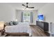Cozy bedroom featuring a ceiling fan, large window, dresser, and a comfortable bed at 1132 Wading Point Blvd, Huger, SC 29450