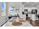 Dining area with white table and chairs adjacent to the open-concept kitchen with stainless steel appliances at 1132 Wading Point Blvd, Huger, SC 29450