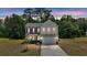 Charming two-story home featuring a two-car garage, black shutters, and a manicured front lawn at 1132 Wading Point Blvd, Huger, SC 29450