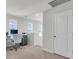 Bright home office with desk overlooking a scenic lake view through large windows at 1132 Wading Point Blvd, Huger, SC 29450