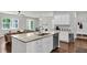 Open-concept kitchen with white cabinets, stainless steel dishwasher, large island, and connection to the living area at 1132 Wading Point Blvd, Huger, SC 29450