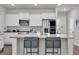 Modern kitchen featuring an island with barstool seating, stainless steel appliances, and ample cabinet space at 1132 Wading Point Blvd, Huger, SC 29450