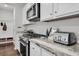 Well-equipped kitchen featuring stainless steel appliances, gas range, and sleek countertops for culinary enthusiasts at 1132 Wading Point Blvd, Huger, SC 29450