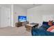 Cozy living room featuring a plush blue sofa and modern entertainment center at 1132 Wading Point Blvd, Huger, SC 29450