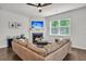 Bright living room features a fireplace with a TV, a ceiling fan, and a window at 1132 Wading Point Blvd, Huger, SC 29450