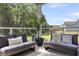 Relaxing patio area with outdoor seating, potted plants, and views of the green backyard at 1132 Wading Point Blvd, Huger, SC 29450