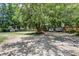 Spacious driveway featuring mature trees, ample parking, and convenient access to the property at 116 Cone Ln, Summerville, SC 29483