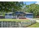 Charming blue home with a white picket fence and front porch at 116 Cone Ln, Summerville, SC 29483