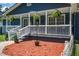 A detailed view of the front porch, featuring white railings and hanging plants at 116 Cone Ln, Summerville, SC 29483