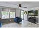 Bright living room with large windows, wood floors, and a comfortable chair at 116 Cone Ln, Summerville, SC 29483