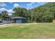 Spacious yard with a blue house, large trees, and parking space at 116 Cone Ln, Summerville, SC 29483