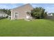 Back of the house with a well-maintained lawn and an exterior door at 120 Larkspur Dr, Goose Creek, SC 29445
