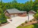 Aerial view of a brick home with mature trees, expansive driveway and additional garage space at 121 Arrowridge Ct, Summerville, SC 29485