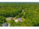 Aerial view of charming home with detached garage, basketball court, and surrounded by mature trees at 121 Arrowridge Ct, Summerville, SC 29485