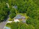 Aerial view of charming red brick home with detached garage, basketball court, and tree-lined property at 121 Arrowridge Ct, Summerville, SC 29485