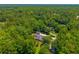 Aerial view of home in a lush neighborhood with mature trees, circular drive and separate garage at 121 Arrowridge Ct, Summerville, SC 29485