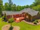 Aerial view of brick home with spacious backyard, wood deck, and well-maintained lawn at 121 Arrowridge Ct, Summerville, SC 29485