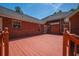 Spacious outdoor deck with red brick home, perfect for entertaining and enjoying the outdoors at 121 Arrowridge Ct, Summerville, SC 29485