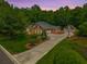 Charming two-story red brick home featuring a long drive, landscaped yard, basketball court and attached garage at 121 Arrowridge Ct, Summerville, SC 29485