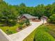 Charming two-story red brick home featuring a long drive, landscaped yard, basketball court and attached garage at 121 Arrowridge Ct, Summerville, SC 29485
