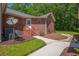 Rear exterior of brick home with a cozy porch entry and well-maintained grounds at 121 Arrowridge Ct, Summerville, SC 29485