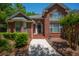 Close up view of a red brick home with lush landscaping and a welcoming front entrance at 121 Arrowridge Ct, Summerville, SC 29485