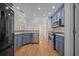 Modern kitchen featuring stainless steel appliances, granite countertops, and blue cabinetry at 121 Arrowridge Ct, Summerville, SC 29485