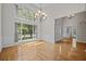 Bright living room with large windows, hardwood floors, and elegant chandelier at 121 Arrowridge Ct, Summerville, SC 29485